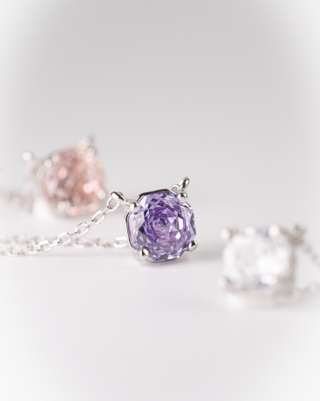 Purple flower-shaped necklace on a light gray background