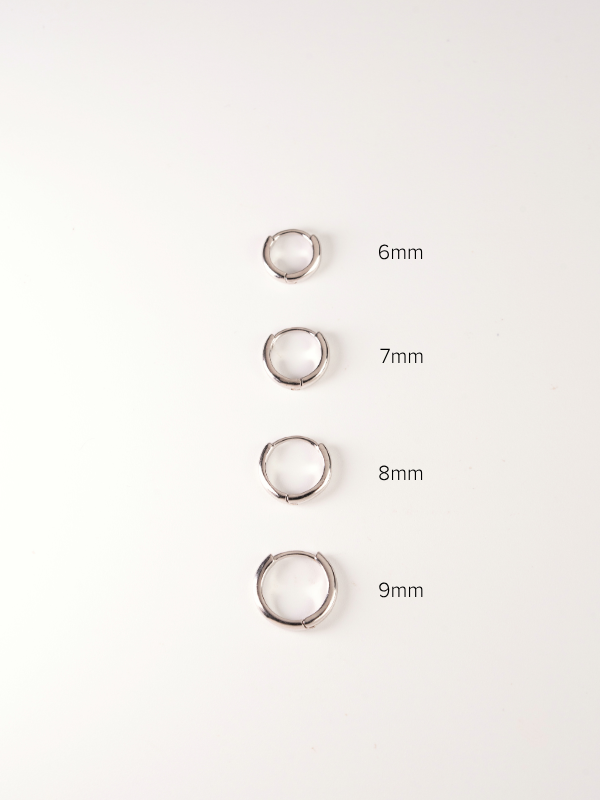 four silver huggie with measurements on a white background