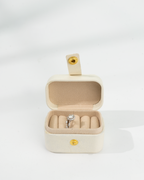 Beige jewelry box with a d color moissanite ring inside 