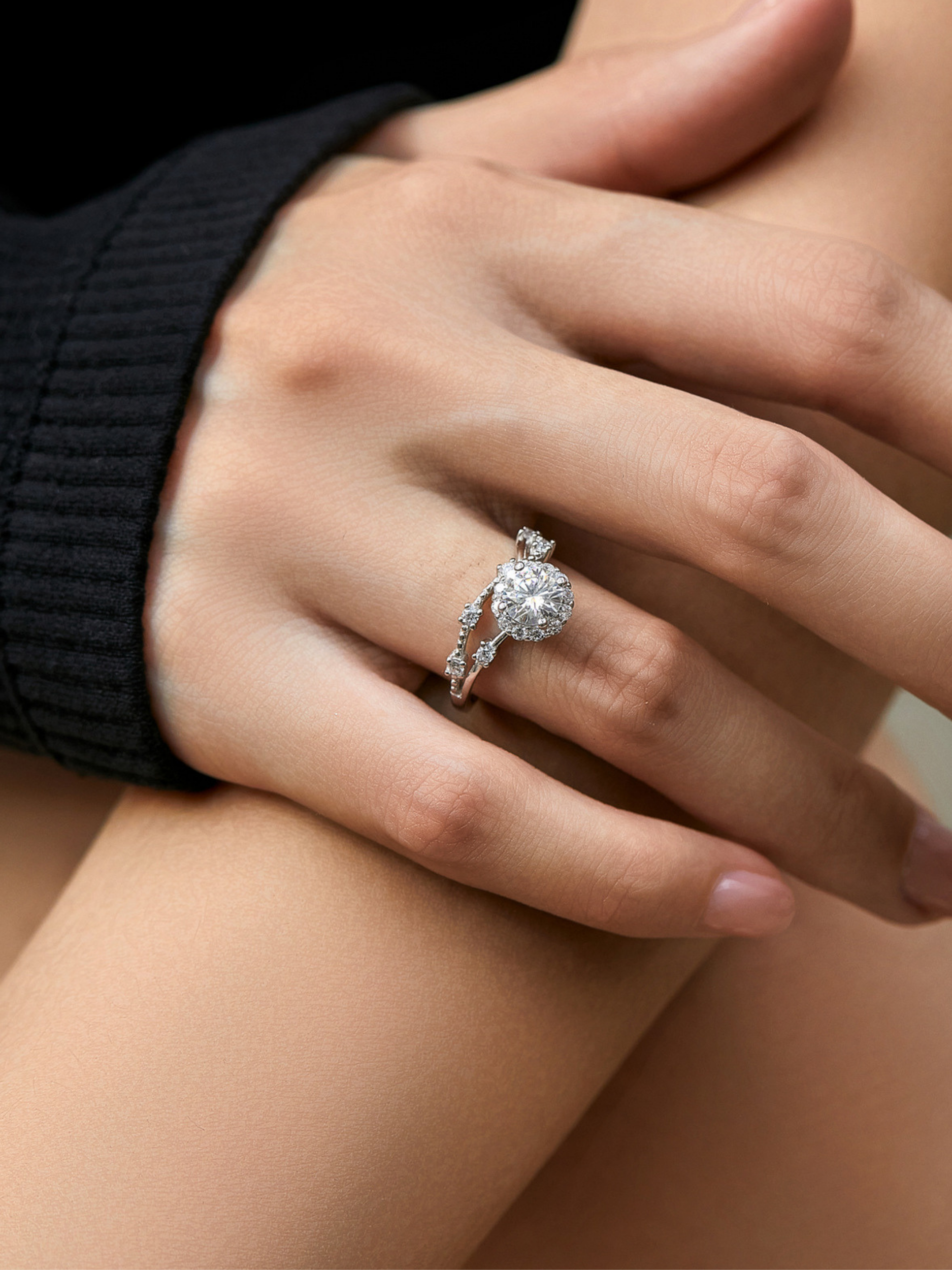 Close-up of a hand wearing a moissanite ring