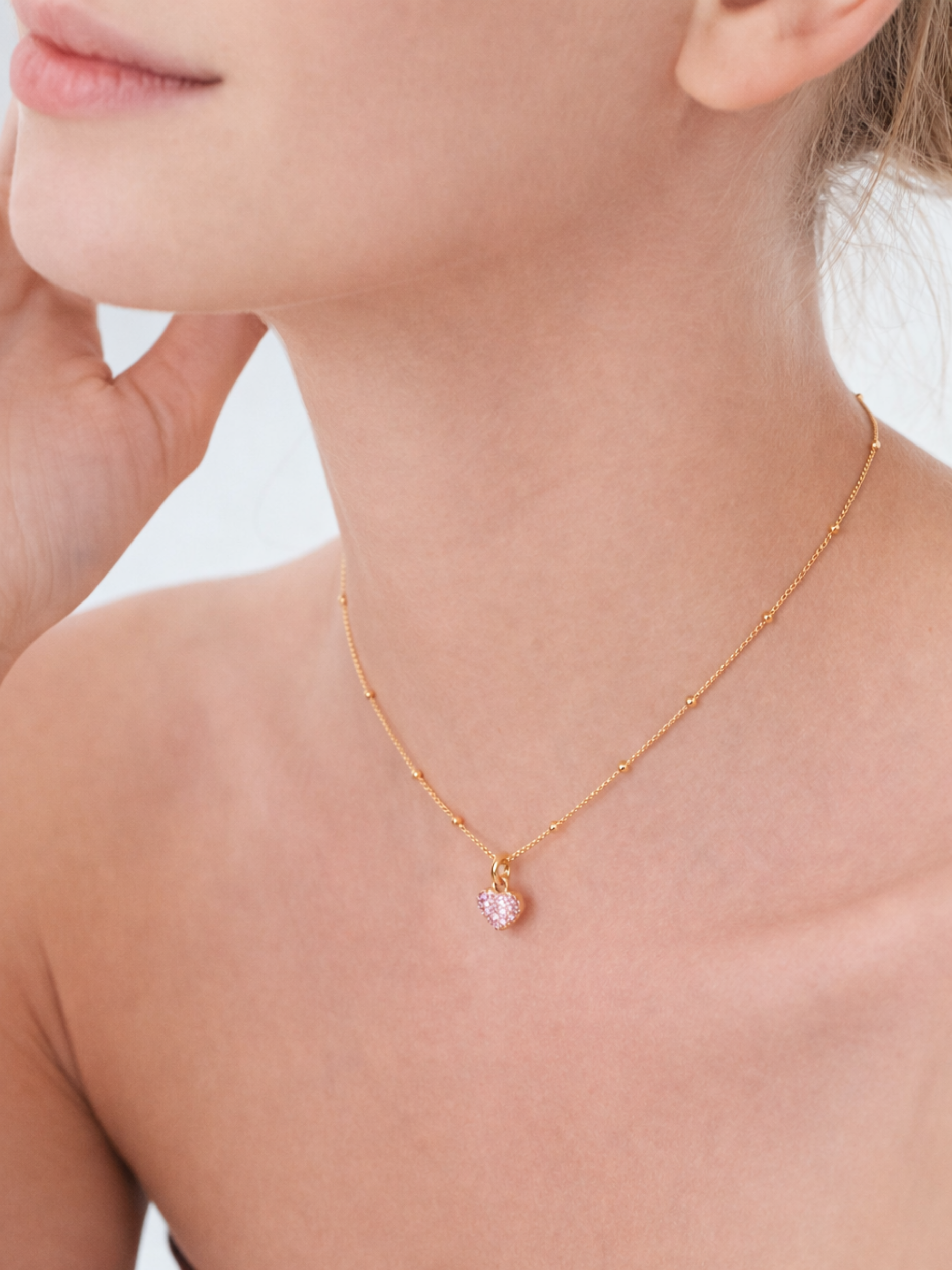 heart necklace on neckline feminine look