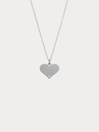 Diamond Heart Engravable Necklace silver tone titanium product flatlay, flat heart pendant on fine cable chain