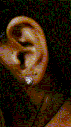 Close-up of EMERY heart-shaped silver studs with pavé detail