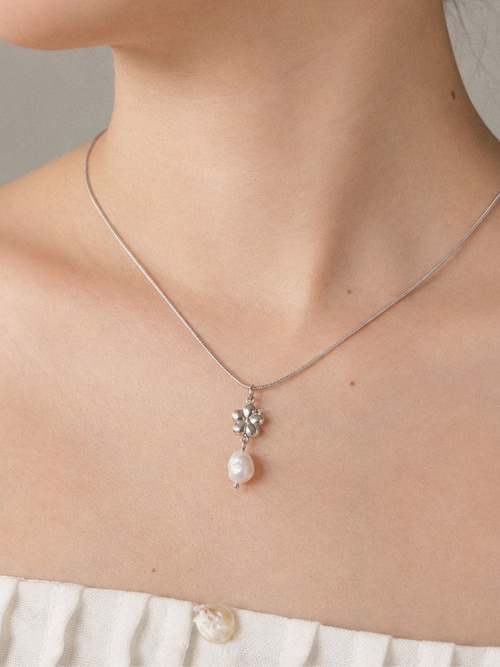Freshwater Pearl Hibiscus Sleek Chain Necklace worn on neckline