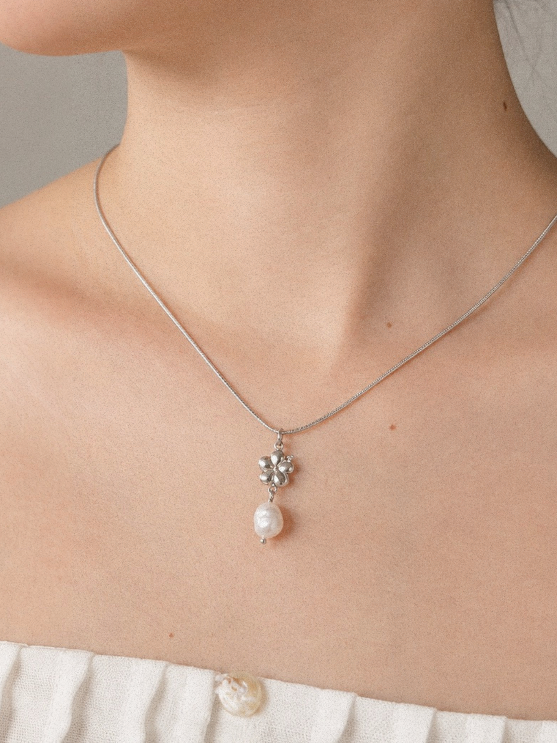 Freshwater Pearl Hibiscus Sleek Chain Necklace worn on neckline