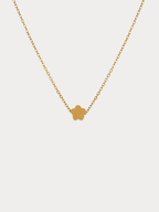 Mini Flower Engravable Necklace in gold titanium with flat flower pendant, studio hero sho