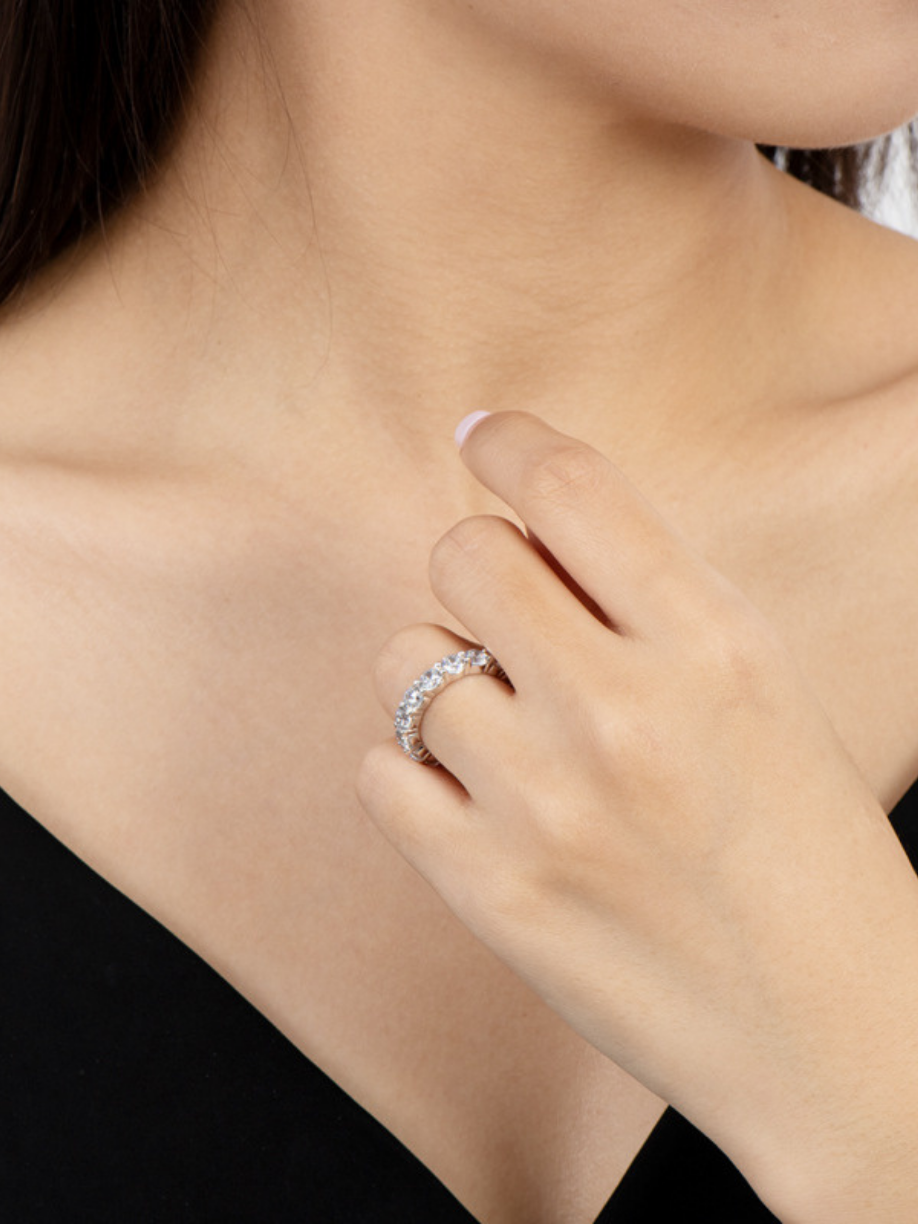 Close-up of a person wearing a silver ring on their finger.