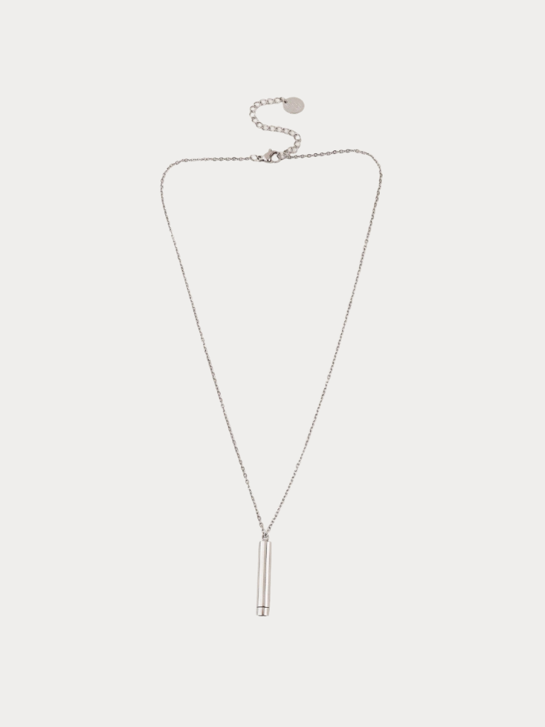 A delicate silver chain necklace with a slim cylindrical pendant, displayed on a light gray background.