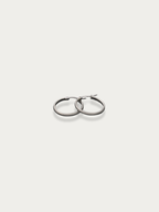 Front view of oversized rose gold textured hoops on a neutral background.