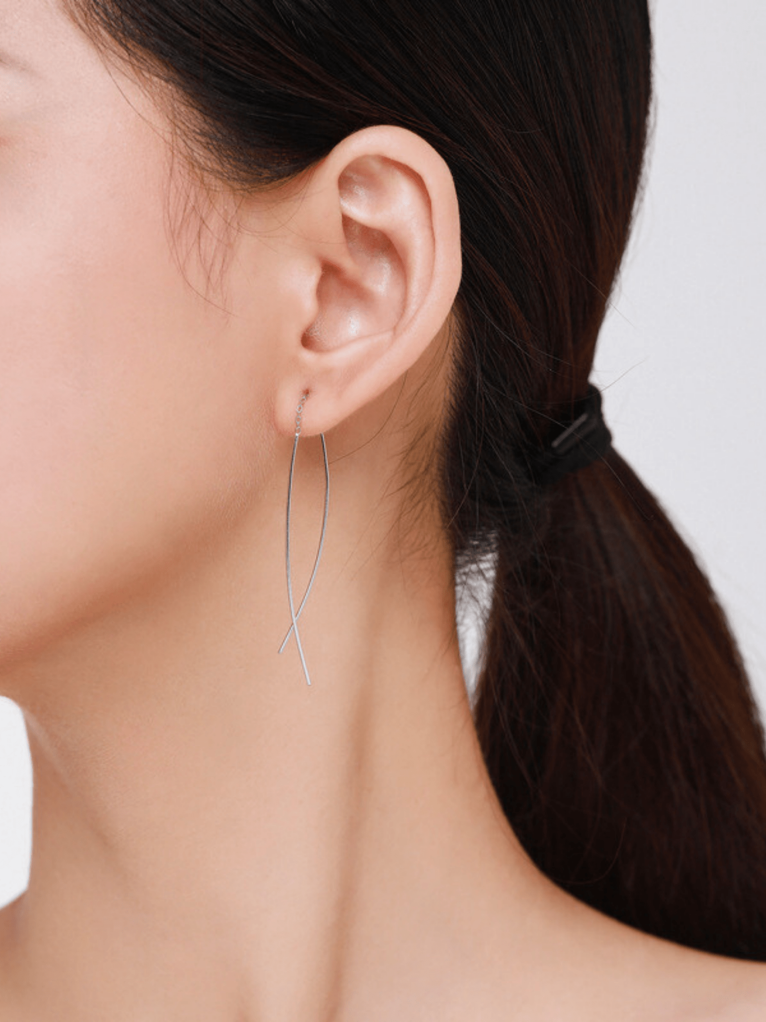 Aeris Threader Earrings worn on ear, 10cm silver drop earrings MNML Malaysia lifestyle shot
