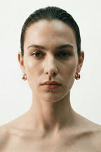 sculptural earrings worn on ear minimalist styling
