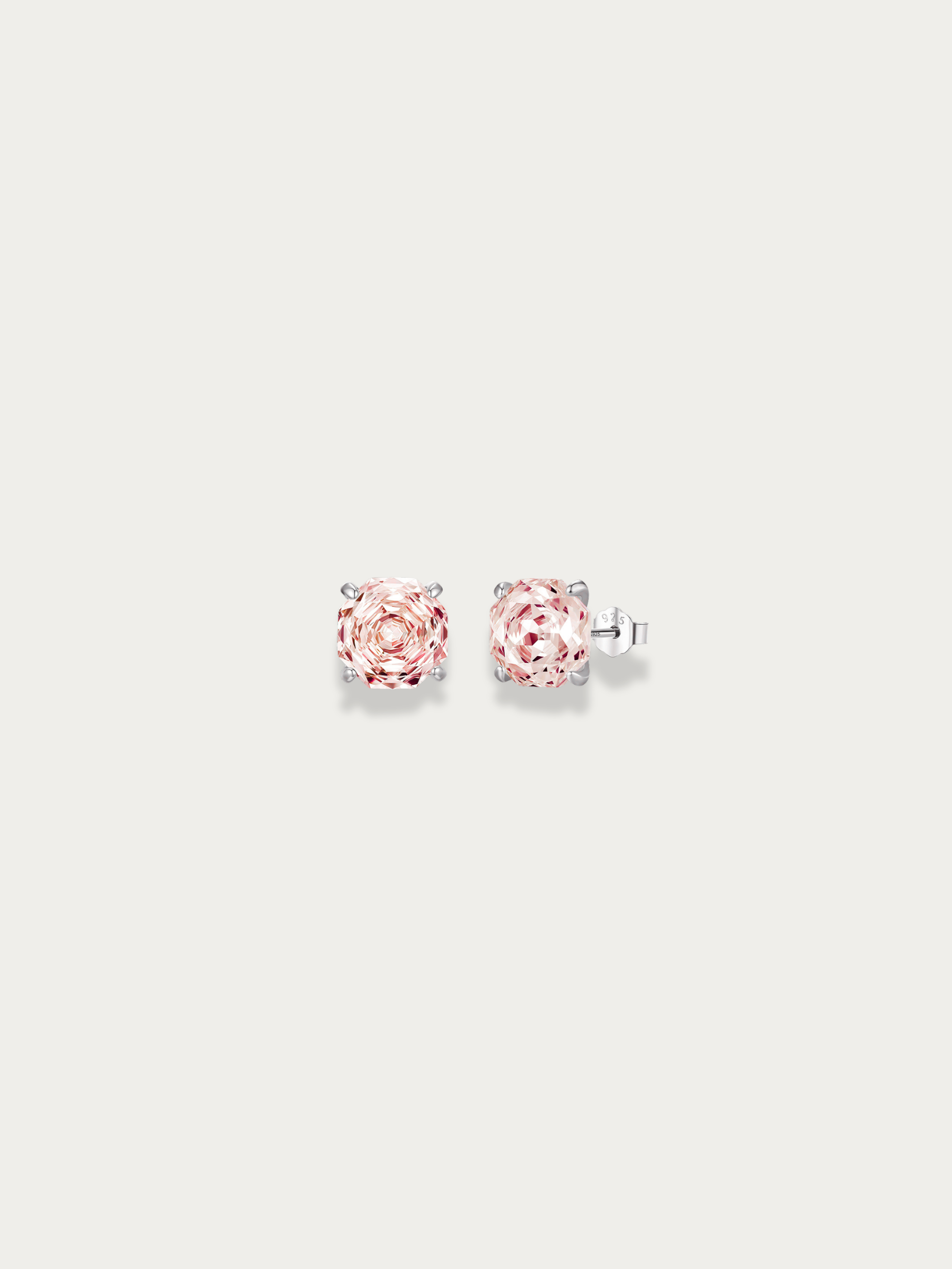 Pair of pink rose cut stud earrings in pink stone on a light gray background