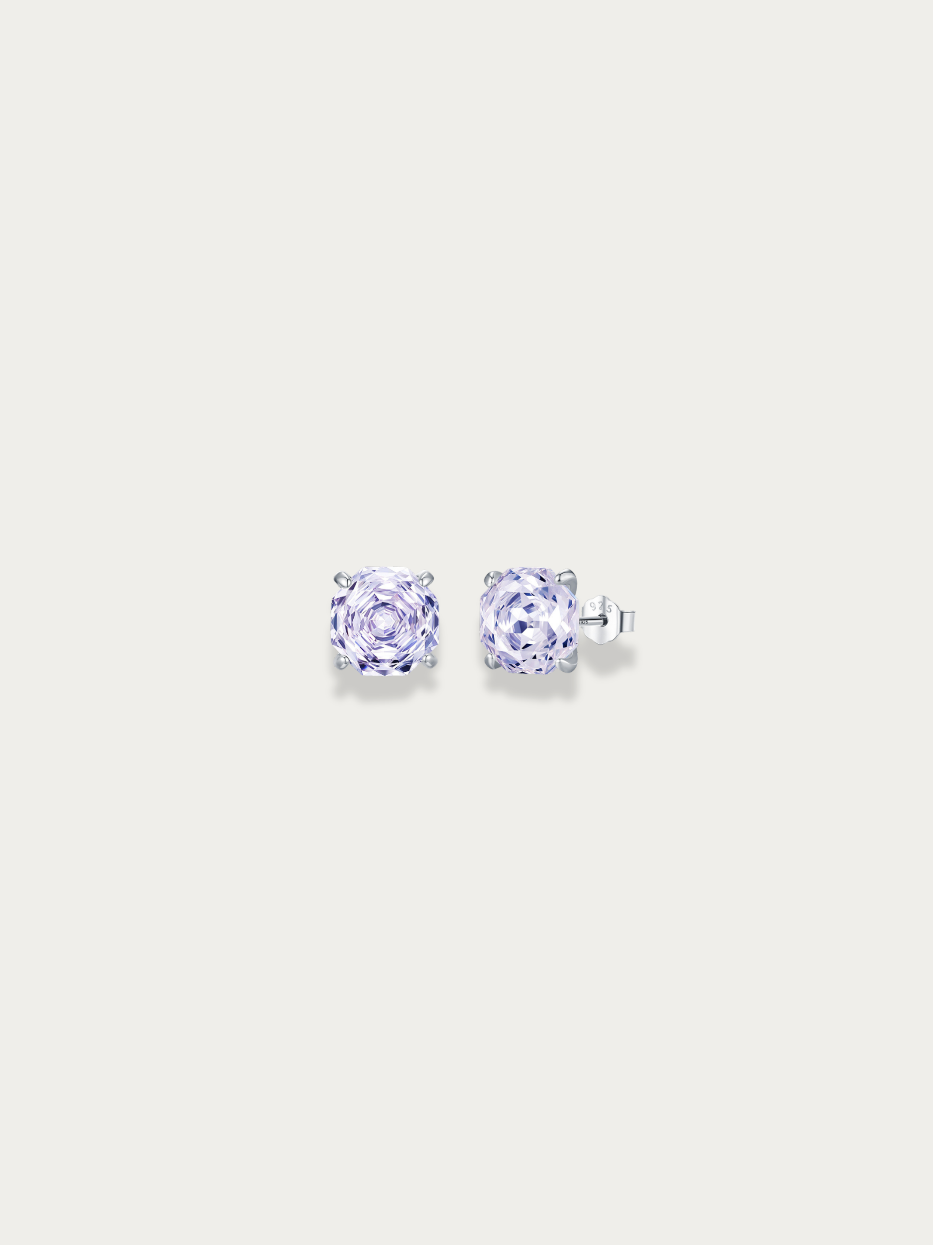 Pair of purple stone with rose cut stud earrings on a light gray background
