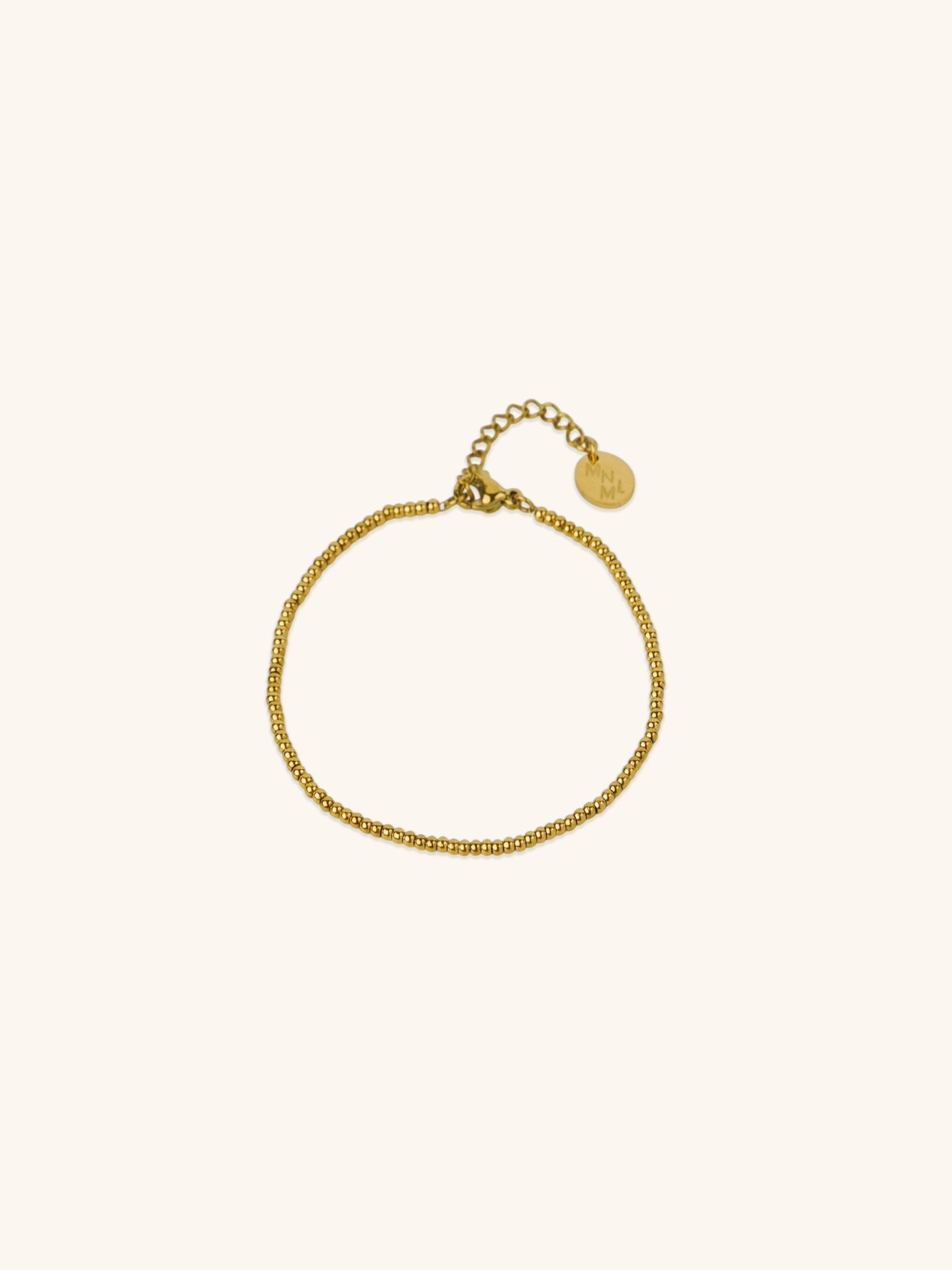 Beaded Bracelet gold tone titanium, continuous ball bead bracelet with MNML disc charm, product flatlay
