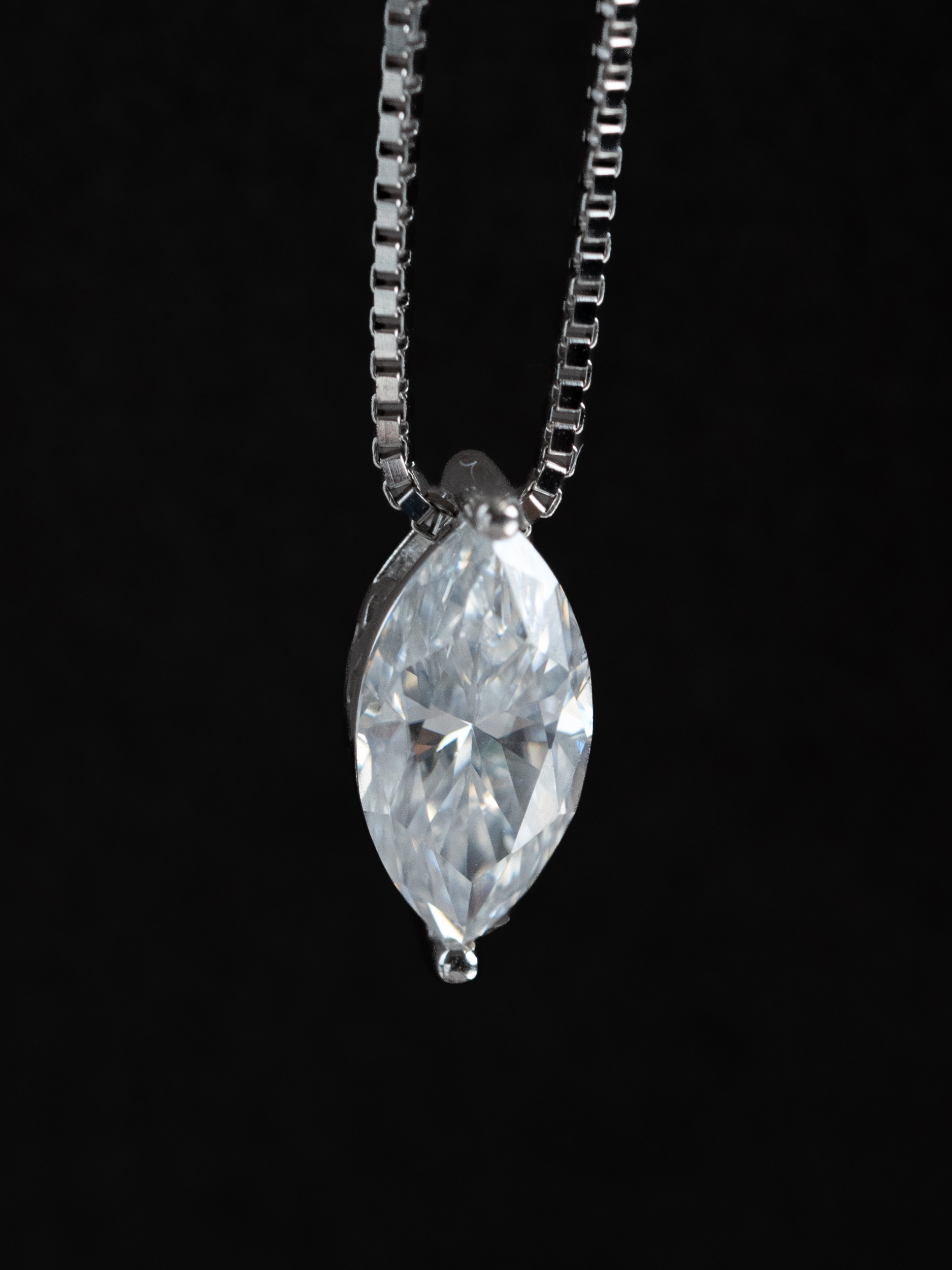 Close-up of marquise-cut moissanite stone on Beatrice necklace showing brilliance and fire
