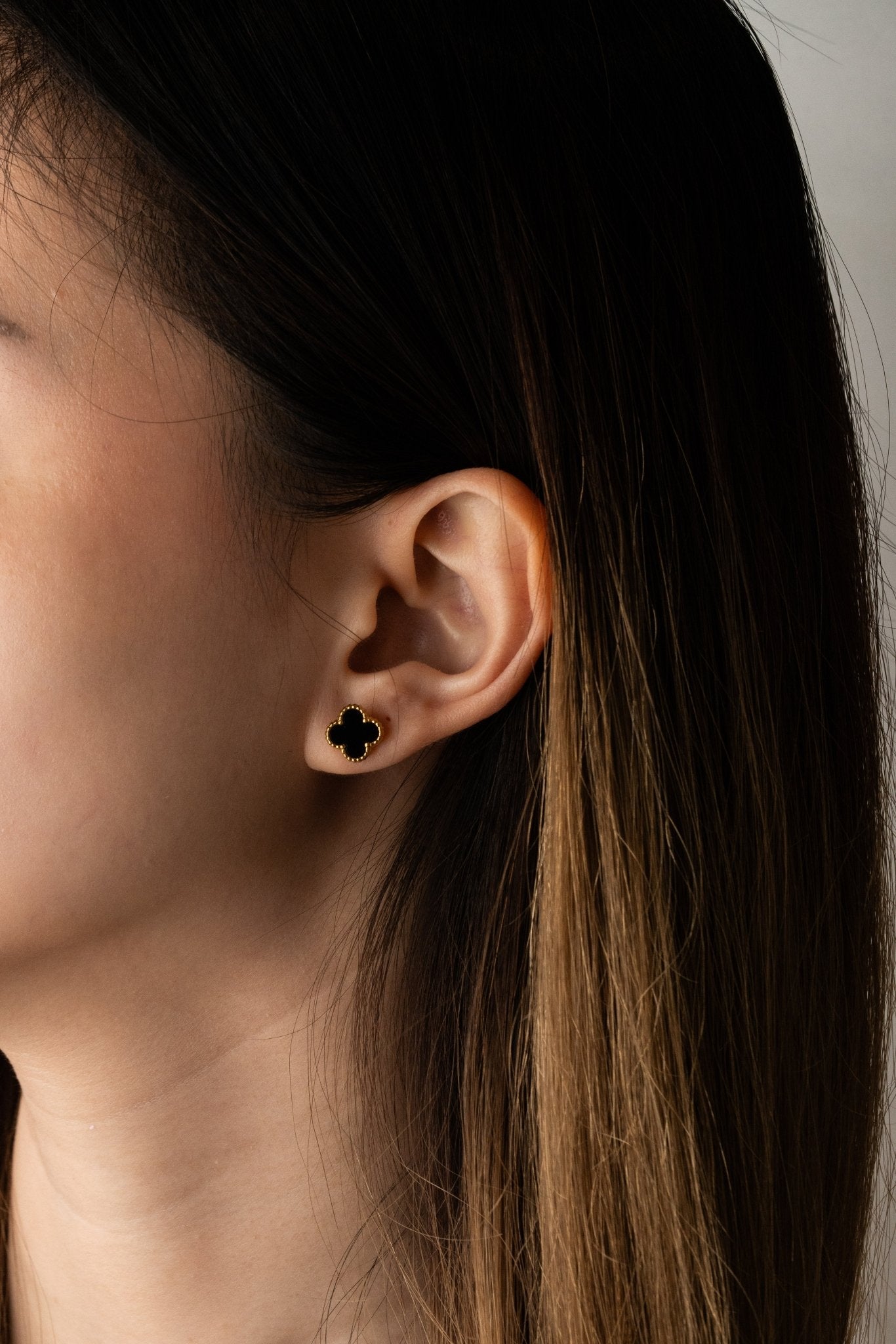 Black Clover Stud Earrings gold tone worn on ear, minimalist clover studs MNML Malaysia lifestyle