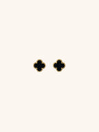 Black Clover Stud Earrings gold tone titanium, four-petal clover with black enamel and milgrain border, product flatlay