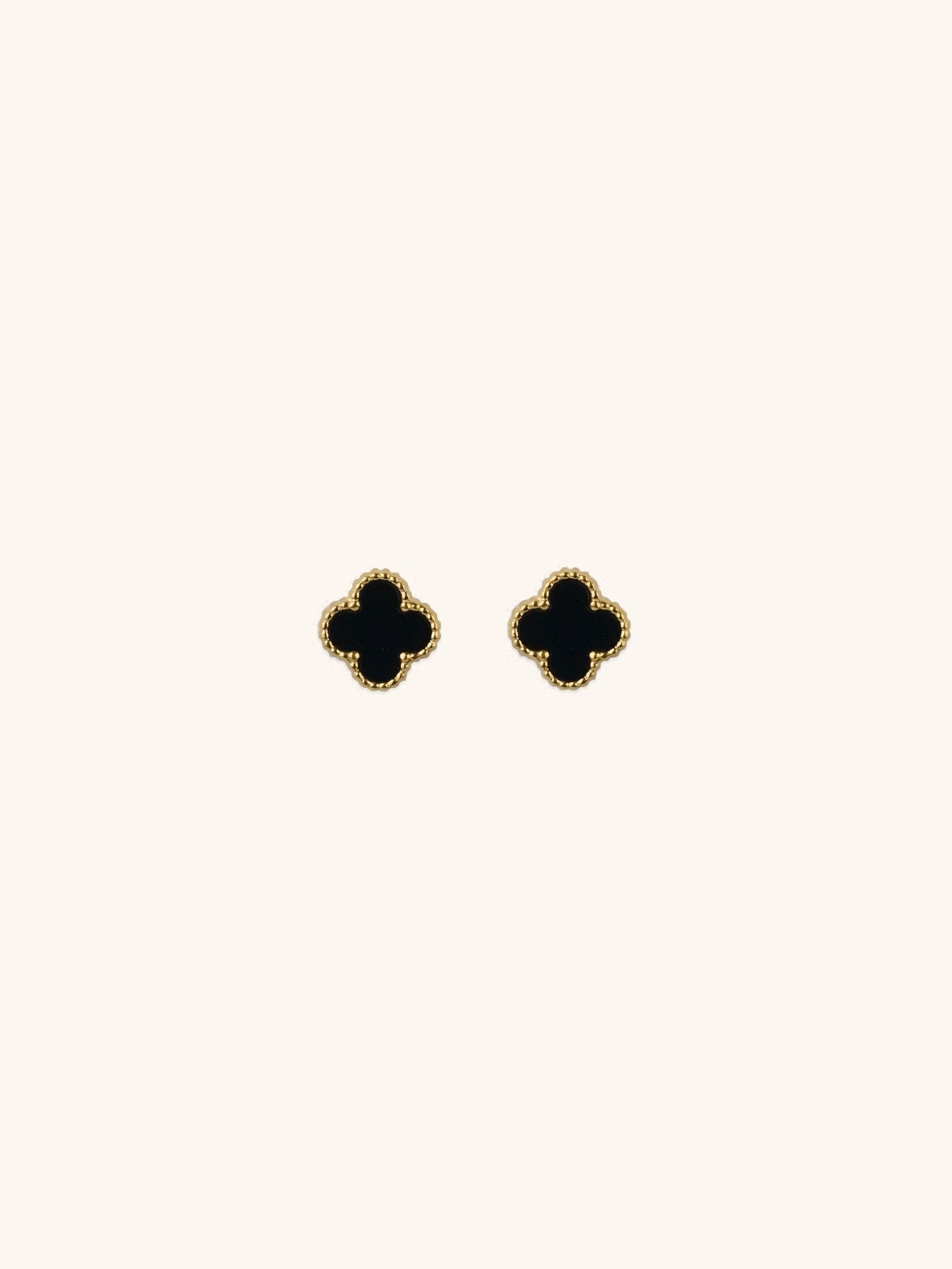 Black Clover Stud Earrings gold tone titanium, four-petal clover with black enamel and milgrain border, product flatlay