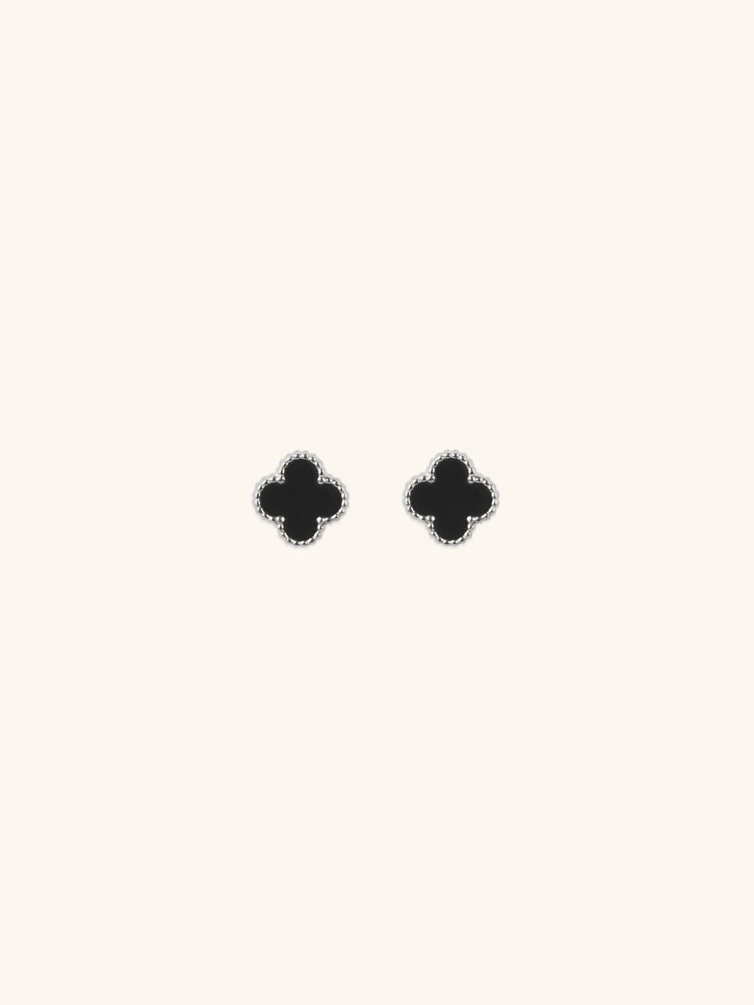 Black Clover Stud Earrings silver tone titanium, four-petal clover with black enamel and milgrain border, product flatlay