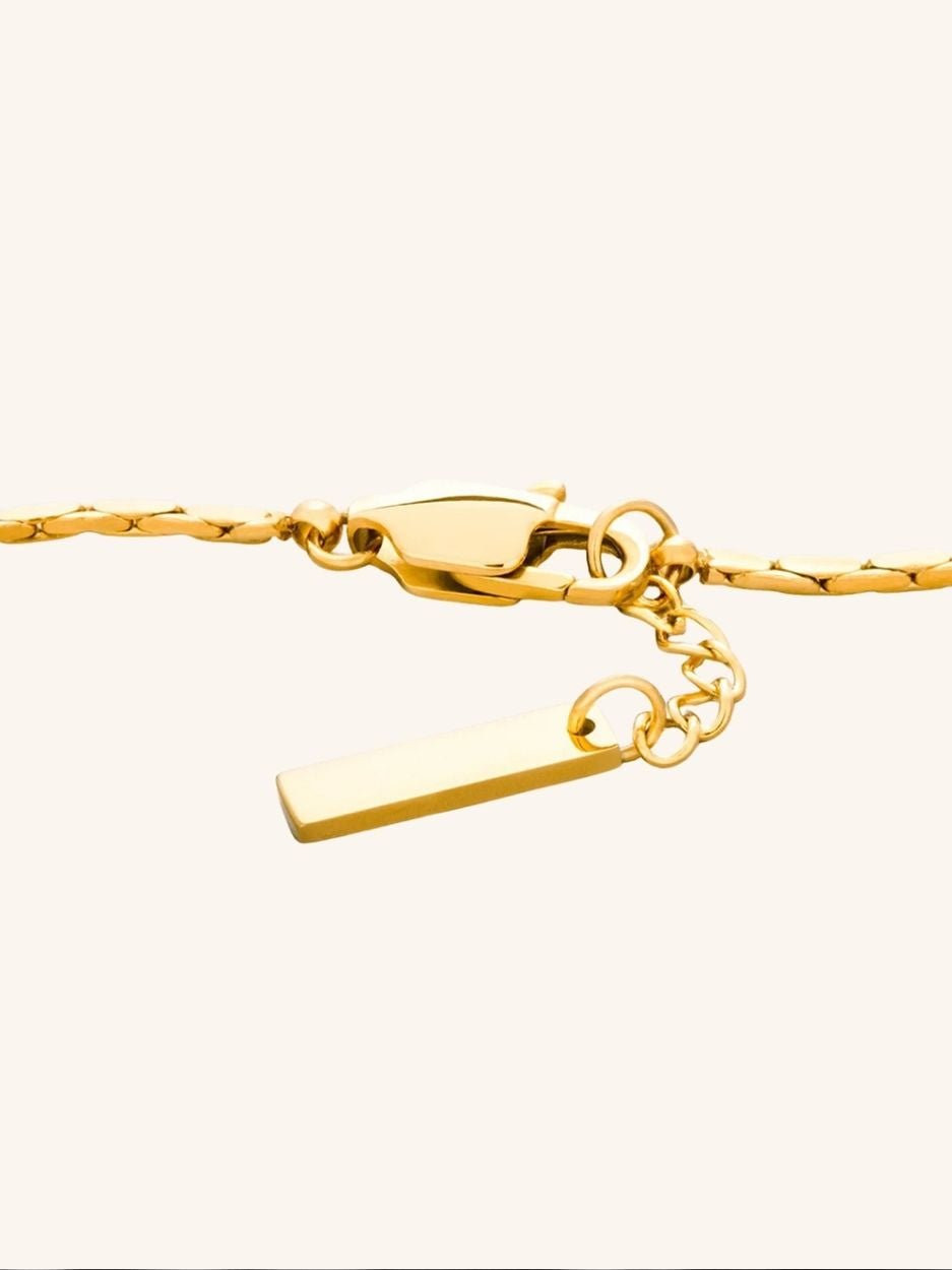 Gold braided wheat chain bracelet close up detail 