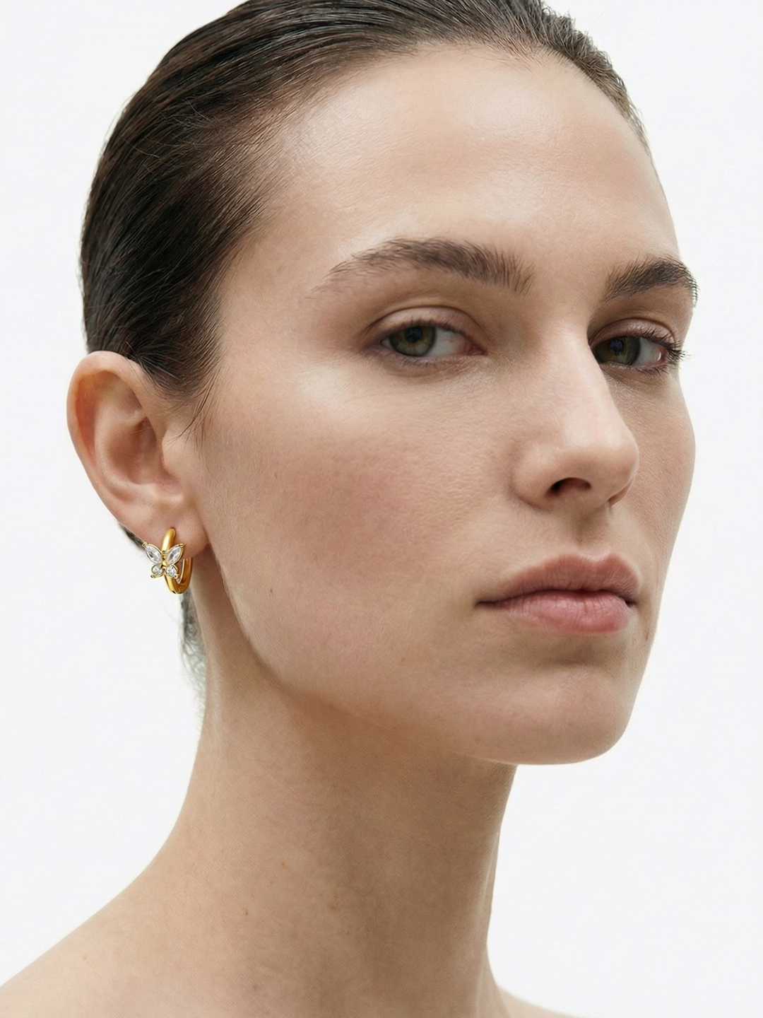 butterfly huggie earrings worn on ear