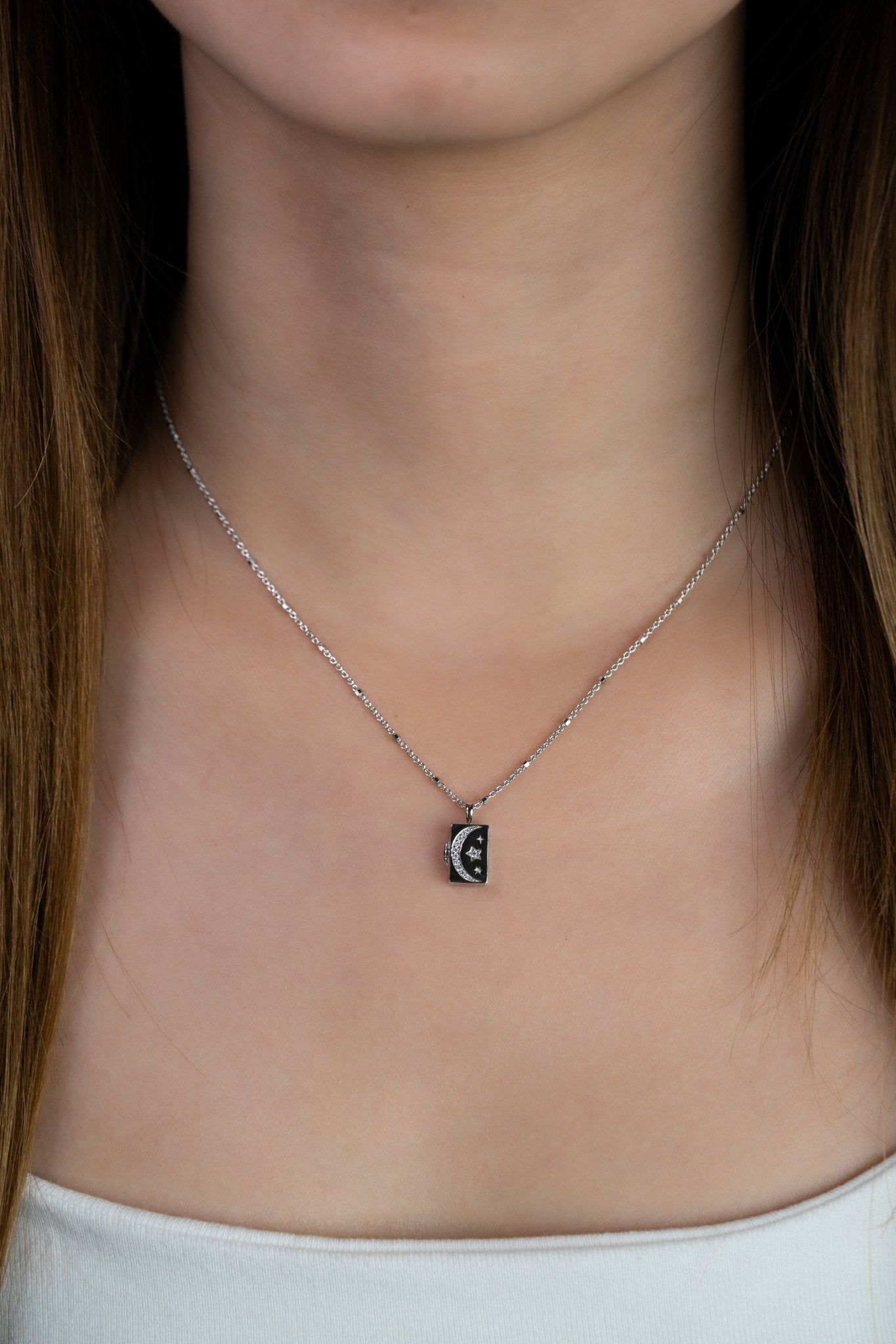 Model wearing CALLISTA Galactic Locket Necklace at the collarbone front view 