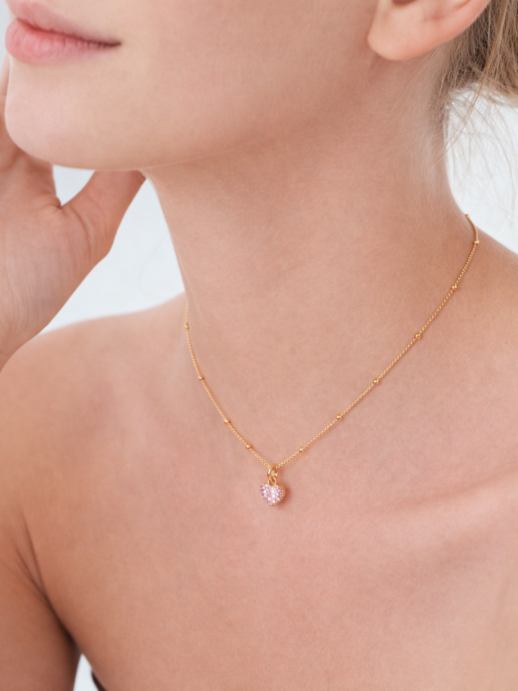 Model wearing Cara Clear Zircon Heart Necklace at collarbone