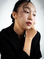 Celeste trinity moissanite stud earrings worn on model's ear