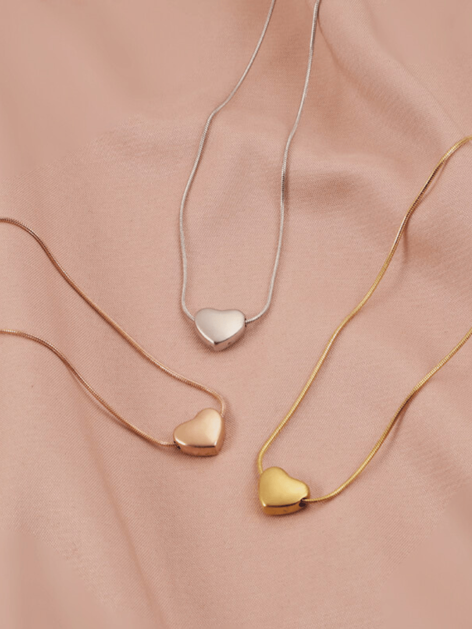 Celeste Dream Heart Necklace in gold, silver and rose gold tone side by side comparison flatlay