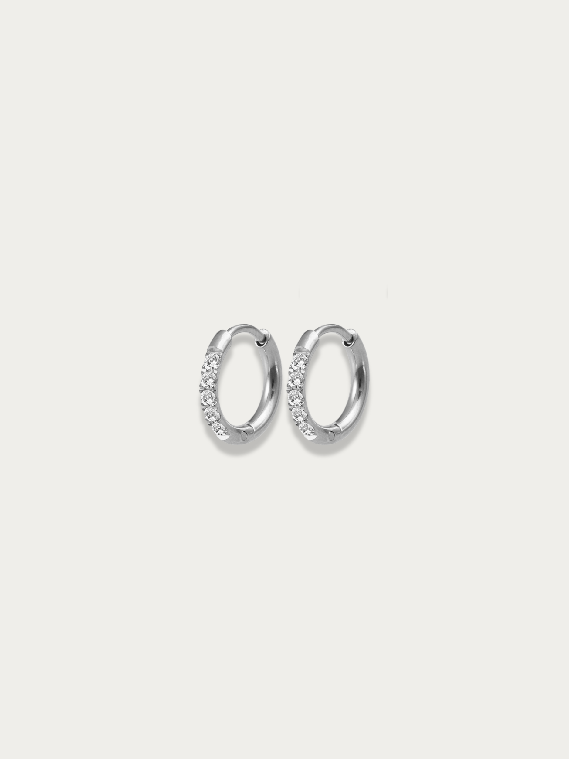 close up pavé stones sparkle huggie earrings in silver color