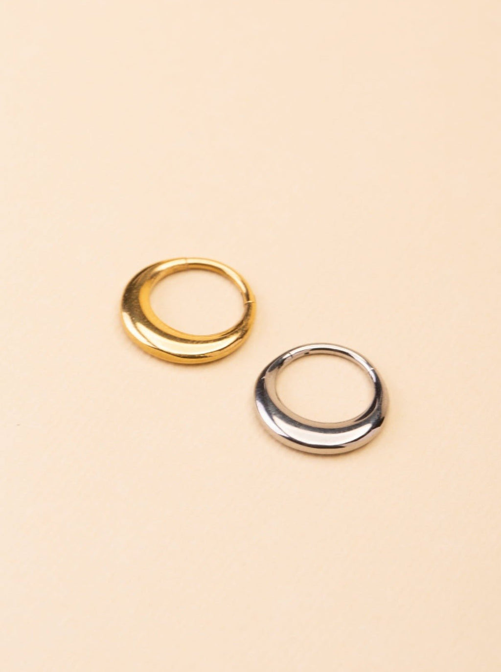 Crescent Nose Ring gold and silver tone titanium, seamless segment ring product flatlay