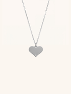 Diamond Heart Engravable Necklace silver tone titanium product flatlay, flat heart pendant on fine cable chain