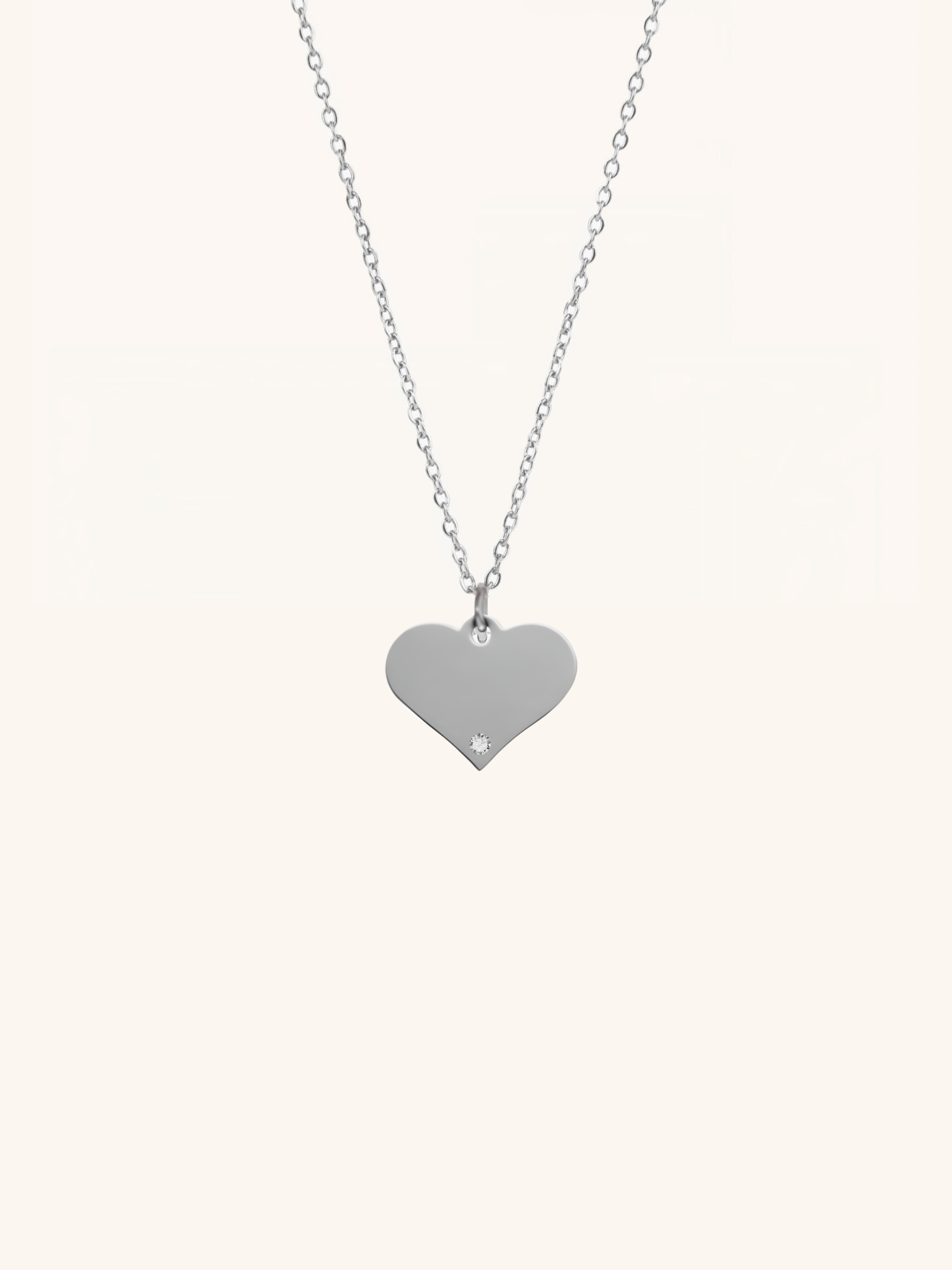 Diamond Heart Engravable Necklace silver tone titanium product flatlay, flat heart pendant on fine cable chain