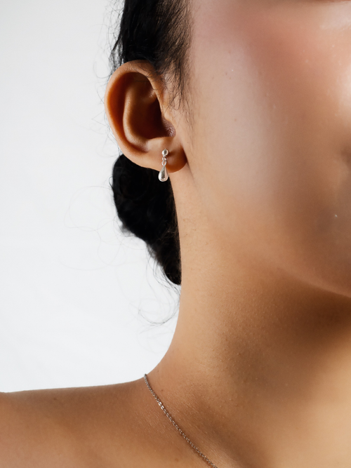 Dylan droplet stud earring worn on model's ear