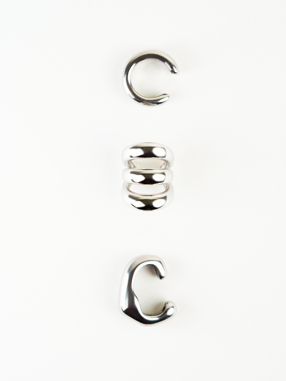Angled view of Echo Triple Statement Ear Cuff showing layered bands