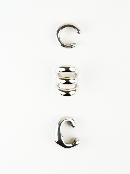 Angled view of Echo Triple Statement Ear Cuff showing layered bands