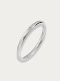 Élan Solitaire Bangle in polished titanium with bezel-set solitaire stone and hinged opening, studio hero shot