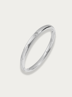 Élan Solitaire Bangle in polished titanium with bezel-set solitaire stone and hinged opening, studio hero shot