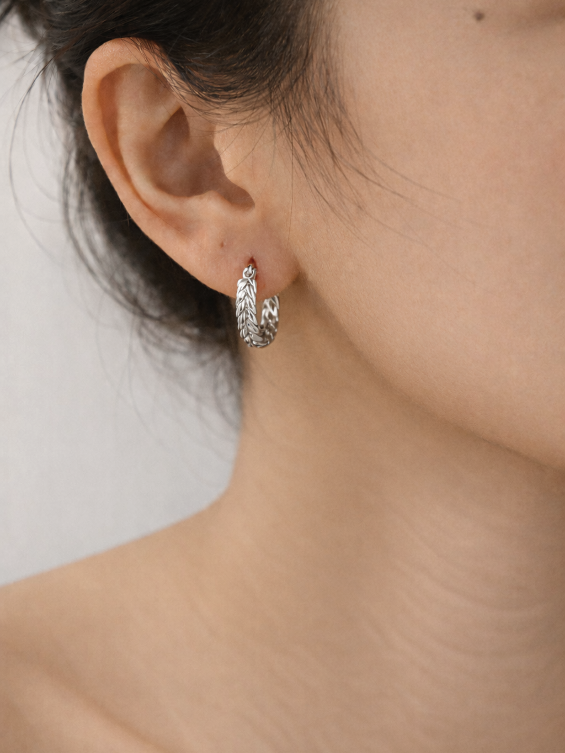 modern braided hoop earrings silver on model