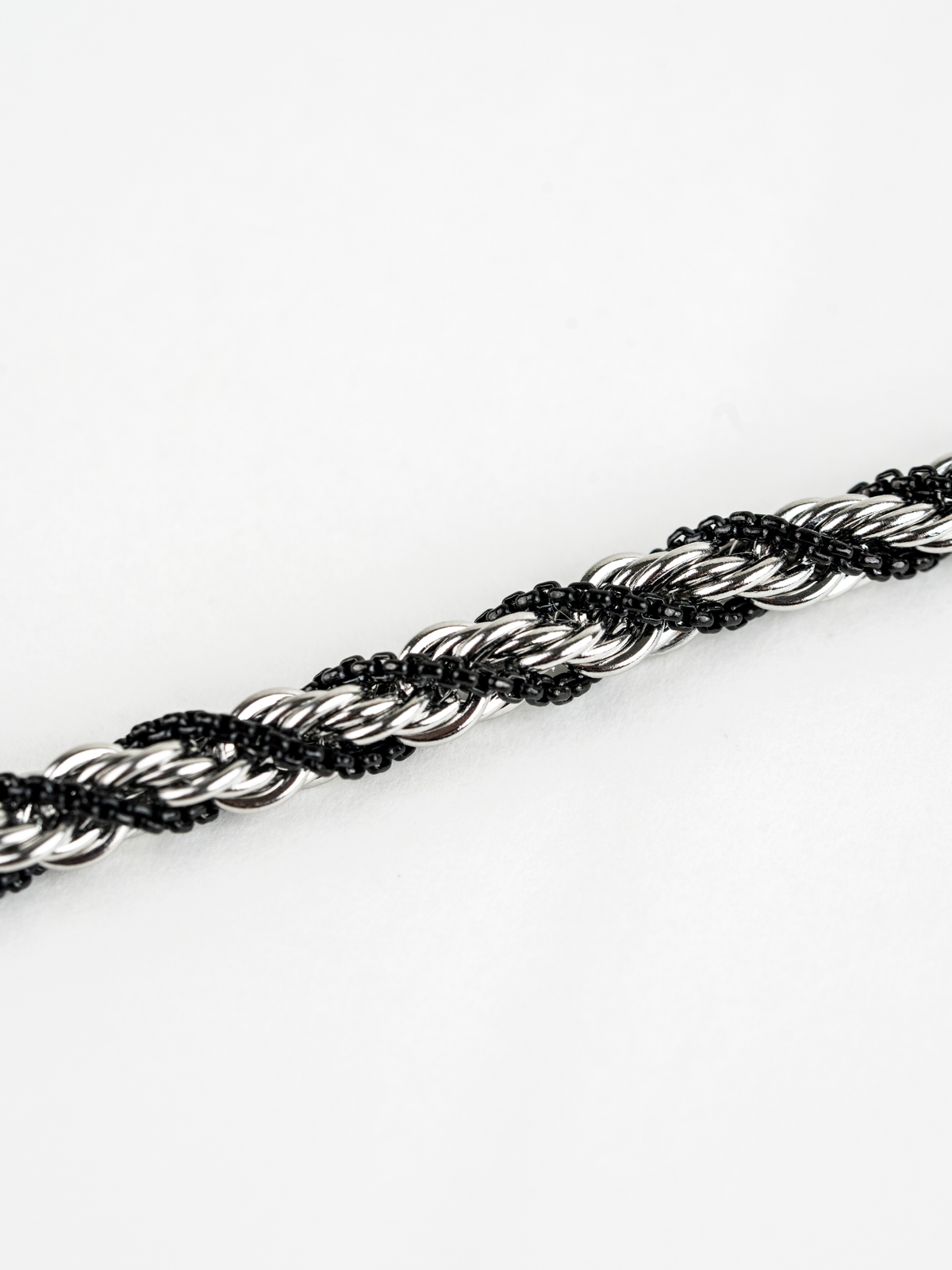 Close-up of twisted silver and black braid on Equilibrium Bracelet