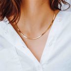 essential herringbone chain necklace worn by a person with a white shirt