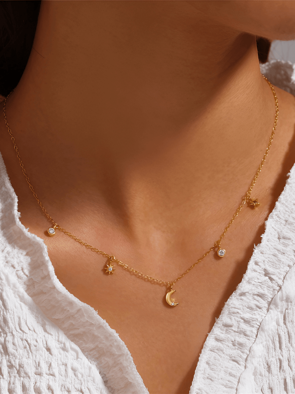 Model wearing ESTELLA Moon and Stars Necklace at the collarbone