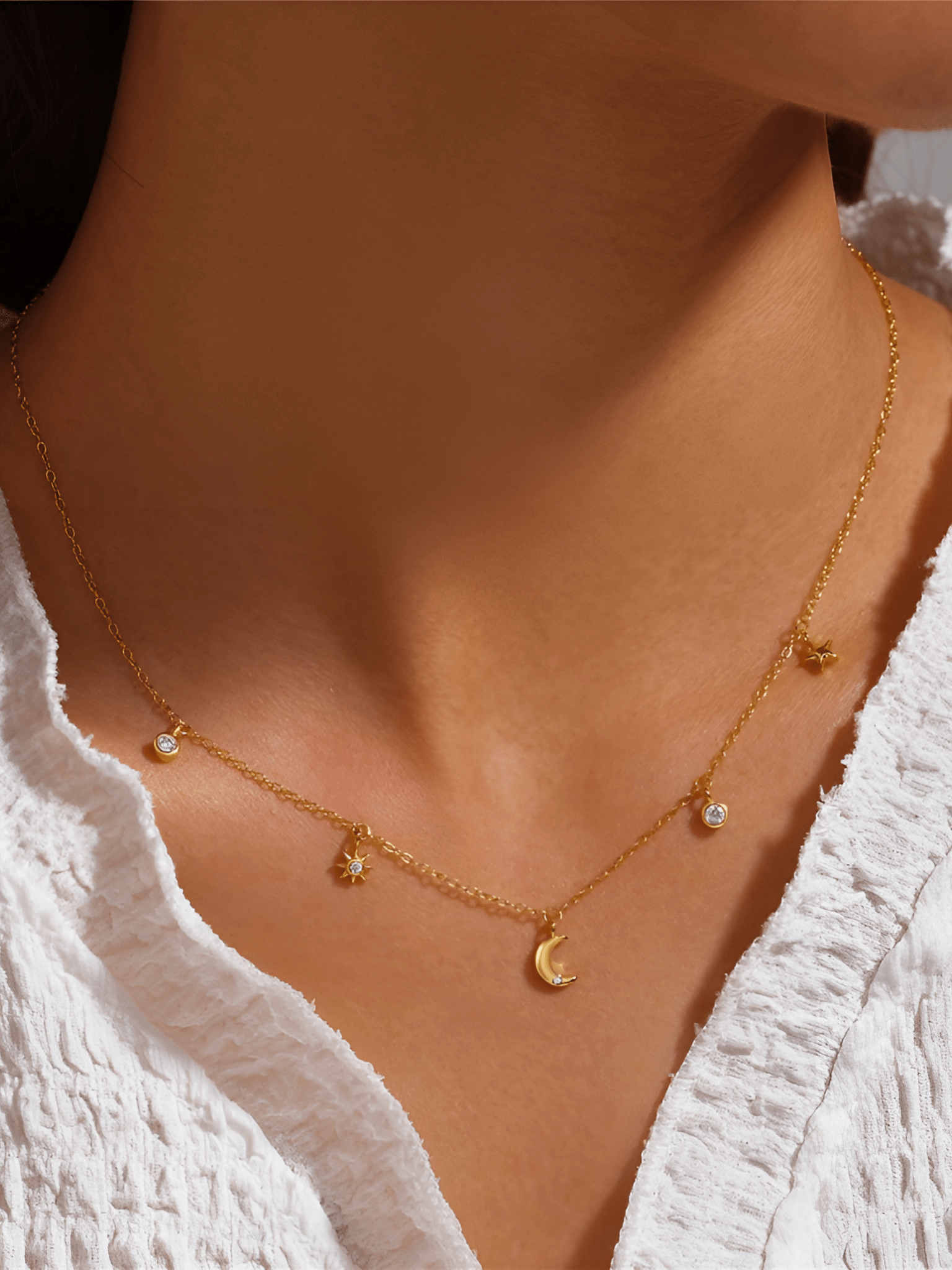 Model wearing ESTELLA Moon and Stars Necklace at the collarbone