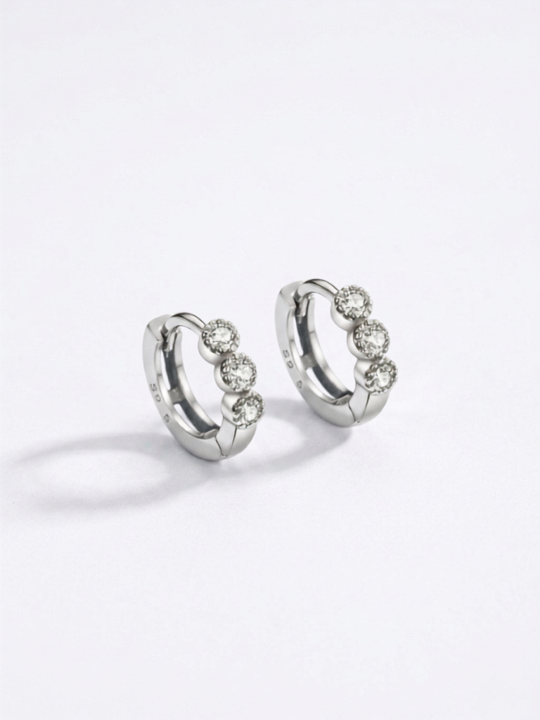 Close-up of EVA Diamond Huggie Earhoop three-stone setting