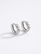 Close-up of EVA Diamond Huggie Earhoop three-stone setting
