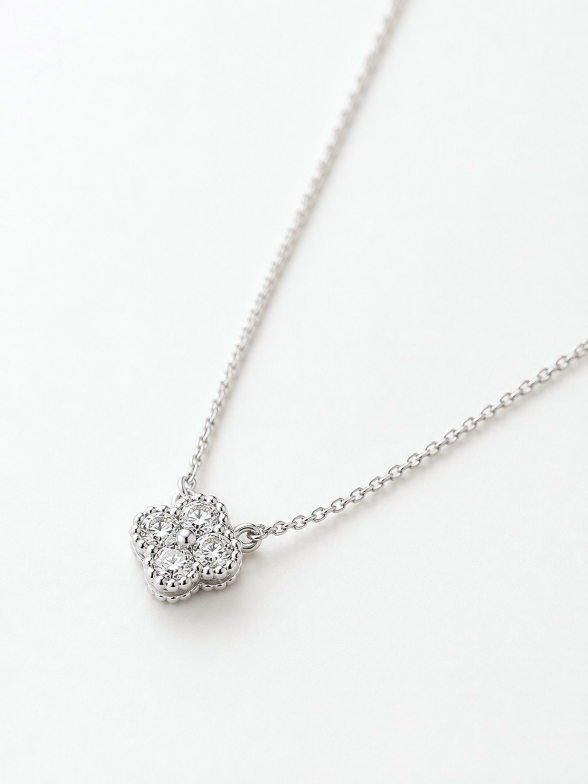 Close-up of four-stone clover pendant on Everette necklace showing brilliance