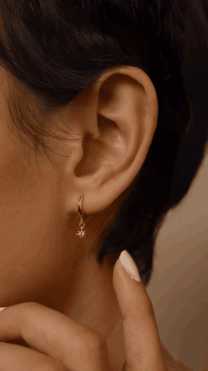 Close-up of FELIX Starlight star-dangle huggie earring