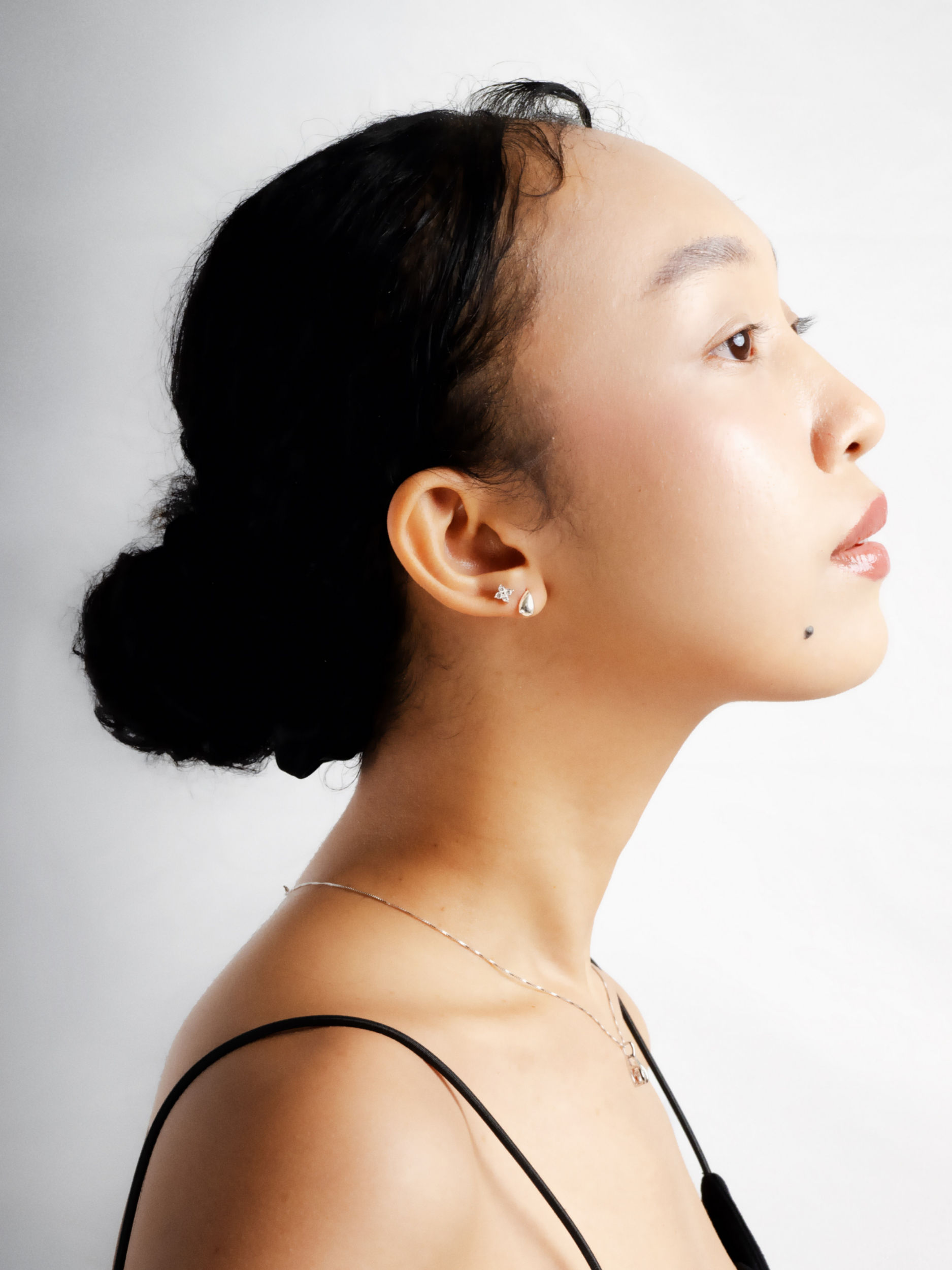 Fiona micro clover stud earring worn on model's ear