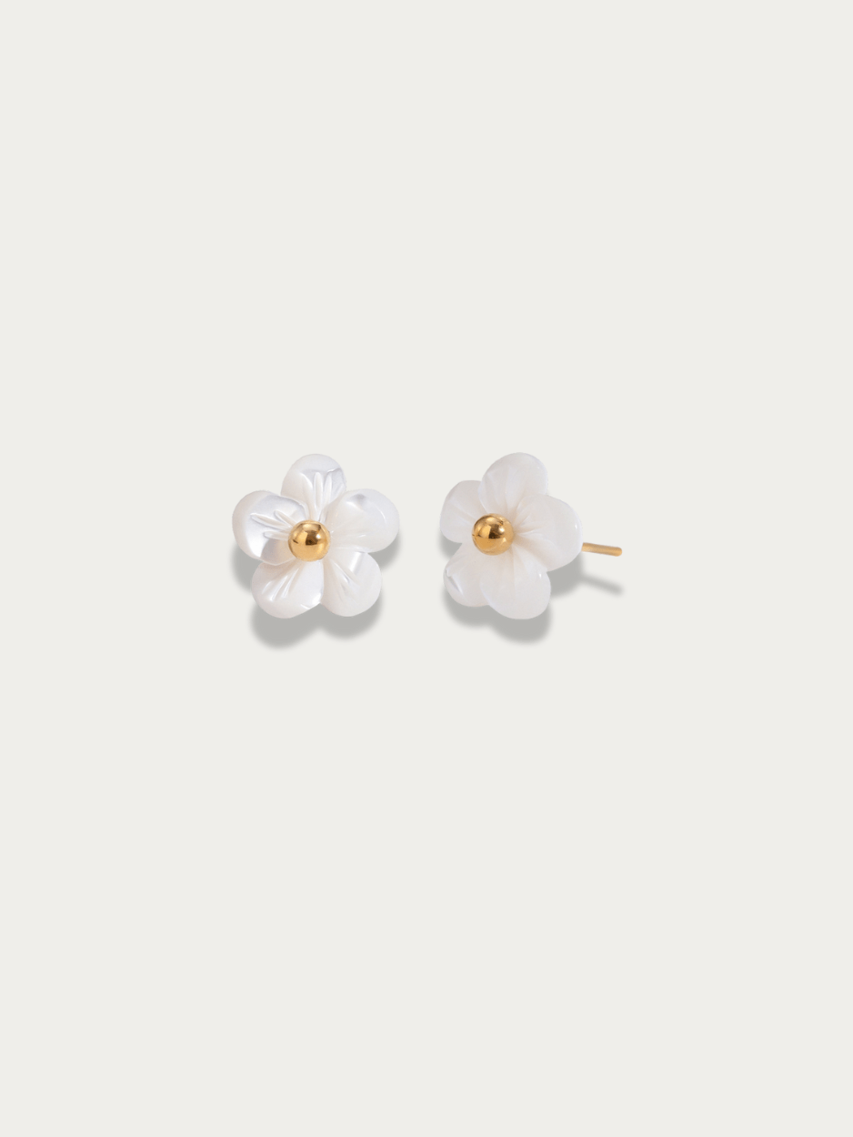 Fleur Blanche Stud Earrings pair, carved white flower motif with gold centre, studio hero shot