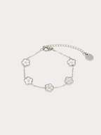 Floral Clovers Bracelet in silver stainless steel with five mother-of-pearl flower station charms, studio hero shot